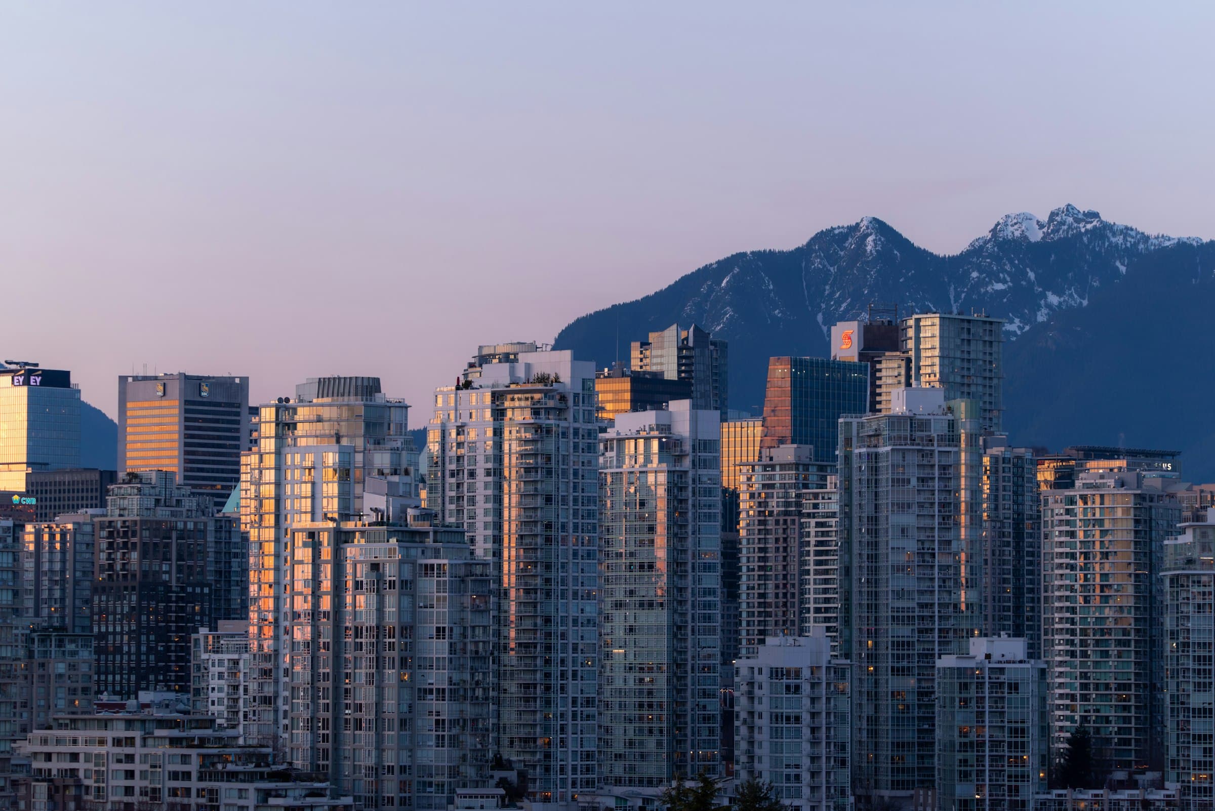 Downtown Vancouver skyline at dusk with the North Shore mountains behind